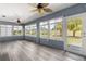 Inviting sun room with large windows offering views of the gorgeous, green, lush backyard at 15825 Sw 11Th Court Rd, Ocala, FL 34473