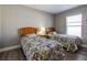 Bright bedroom featuring two twin beds, soft lighting, and a serene, comfortable ambiance at 1690 Sw 158Th Ln, Ocala, FL 34473