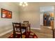 Cozy dining area with wood floors, pendant lighting and a view into the kitchen at 1690 Sw 158Th Ln, Ocala, FL 34473
