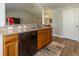 Well-lit kitchen features wood cabinets, stainless steel appliances, granite counters and wood-look floors at 1690 Sw 158Th Ln, Ocala, FL 34473