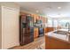 Bright kitchen boasts stainless steel refrigerator, oven, microwave, wood cabinets and wood-look floors at 1690 Sw 158Th Ln, Ocala, FL 34473