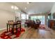 Spacious living room with wood floors, slider to the backyard and comfortable leather furniture at 1690 Sw 158Th Ln, Ocala, FL 34473