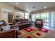 Comfortable living room with leather furniture, wood-look floors and a view of the kitchen at 1690 Sw 158Th Ln, Ocala, FL 34473