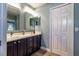 Main bathroom features double sinks, vanity with storage, modern mirrors and a closet at 1690 Sw 158Th Ln, Ocala, FL 34473