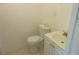 Powder room with standard toilet and sink with white vanity and tiled floor at 17315 Se 18Th St, Silver Springs, FL 34488