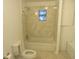 Bright bathroom featuring a shower-tub combination with marble-look tile surround at 17315 Se 18Th St, Silver Springs, FL 34488