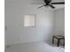 This bedroom has tile floors, a ceiling fan, a window with blinds, and a small table at 17315 Se 18Th St, Silver Springs, FL 34488