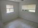 Bedroom with two windows letting in natural light and tile flooring at 17315 Se 18Th St, Silver Springs, FL 34488
