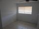 The bedroom featuring neutral walls, tile floors, and a window for natural light at 17315 Se 18Th St, Silver Springs, FL 34488