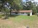 Cozy one-story house surrounded by lush greenery, creating a private and serene atmosphere at 17315 Se 18Th St, Silver Springs, FL 34488