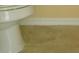 Close-up of a pristine white toilet and neutral-toned tile flooring at 1754 Sw 160Th Pl, Ocala, FL 34473