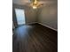 Bedroom featuring updated flooring, ceiling fan, and natural light from the window at 1809 Sw 29Th Ter, Ocala, FL 34474