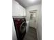 Laundry room with modern washer, dryer, and white cabinets at 1809 Sw 29Th Ter, Ocala, FL 34474