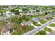 Aerial view of a home with a landscaped front yard and a nearby pond and golf course at 2158 Nw 50Th Ave, Ocala, FL 34482
