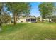 The backyard has a screened in porch with a large, lush green lawn at 2158 Nw 50Th Ave, Ocala, FL 34482