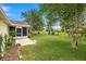 Expansive backyard with mature trees, lush grass, screened in porch, and serene views at 2158 Nw 50Th Ave, Ocala, FL 34482