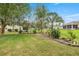 Beautifully landscaped backyard featuring manicured lawn and a variety of plants and trees at 2158 Nw 50Th Ave, Ocala, FL 34482