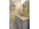 Well-lit bathroom featuring a vanity with cabinets and a mirror at 2158 Nw 50Th Ave, Ocala, FL 34482