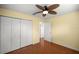 Bright bedroom with a ceiling fan, hardwood floors, and a spacious closet at 2158 Nw 50Th Ave, Ocala, FL 34482