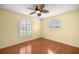 Cozy bedroom with hardwood floors, ceiling fan, and bright windows allowing natural light at 2158 Nw 50Th Ave, Ocala, FL 34482
