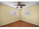 Bedroom showcasing hardwood floors, white trim windows, and a ceiling fan at 2158 Nw 50Th Ave, Ocala, FL 34482