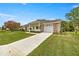 This home features a well-manicured lawn, a two-car garage, and an inviting front porch at 2158 Nw 50Th Ave, Ocala, FL 34482