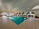 Beautiful indoor pool with natural light, with an attached seating area for community enjoyment at 2158 Nw 50Th Ave, Ocala, FL 34482