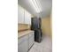 Laundry room featuring stacked washer and dryer, white cabinets, and tiled floor at 2158 Nw 50Th Ave, Ocala, FL 34482