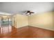 Bright living room with hardwood floors, ceiling fan, and access to outdoor area at 2158 Nw 50Th Ave, Ocala, FL 34482