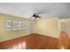 Bright living room with hardwood floors, ceiling fan, and a large window with shutter-style blinds at 2158 Nw 50Th Ave, Ocala, FL 34482