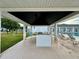 Poolside view with shaded cabana, lounge chairs, and a glimpse of the main building at 2158 Nw 50Th Ave, Ocala, FL 34482