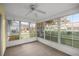 Enclosed sunroom with large windows offering a view of the landscaped backyard at 2158 Nw 50Th Ave, Ocala, FL 34482