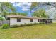 Property boasts a lush lawn, providing a serene outdoor space with a porch at 2220 Ne 41St St, Ocala, FL 34479