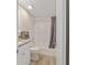 Well-lit bathroom featuring a shower-tub combination and granite countertop vanity with white cabinets at 2220 Ne 41St St, Ocala, FL 34479
