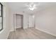 Bright bedroom features a ceiling fan, neutral walls, and open closet for ample storage at 2220 Ne 41St St, Ocala, FL 34479