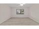 Bedroom featuring light gray wood flooring, white walls, ceiling fan, and a large window at 2220 Ne 41St St, Ocala, FL 34479