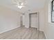 Bedroom featuring light gray wood flooring, ceiling fan, and a closet at 2220 Ne 41St St, Ocala, FL 34479