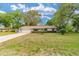 Charming single-story home with a well-manicured lawn and mature trees at 2220 Ne 41St St, Ocala, FL 34479