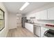 Renovated kitchen with stainless steel appliances and gray countertops and floors at 2220 Ne 41St St, Ocala, FL 34479