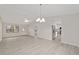 Spacious living room with gray floors and natural light pouring through the windows at 2220 Ne 41St St, Ocala, FL 34479