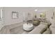 Staged living room showcasing modern flooring, a dining area and plenty of natural light at 2220 Ne 41St St, Ocala, FL 34479