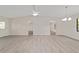 Bright living room featuring new gray flooring, ceiling fan, and large window for ample natural light at 2220 Ne 41St St, Ocala, FL 34479