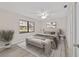 Staged main bedroom with a ceiling fan, large windows and neutral decor at 2220 Ne 41St St, Ocala, FL 34479