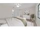 Comfortable main bedroom with ceiling fan, en suite bathroom and bright windows at 2220 Ne 41St St, Ocala, FL 34479