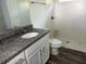 Bathroom featuring a vanity with granite countertop, white cabinets, and walk-in shower at 227 Fisher Run, Ocklawaha, FL 32179