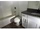 Bathroom with granite countertop vanity, white cabinets, and tub at 227 Fisher Run, Ocklawaha, FL 32179