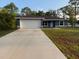 Charming single-story home featuring a two-car garage and well-maintained lawn at 227 Fisher Run, Ocklawaha, FL 32179
