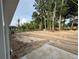 This partially cleared backyard is surrounded by a mature tree line and a chain-link fence at 28 Bahia Pass Dr, Ocala, FL 34472