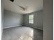 Bright bedroom with tiled floors, a ceiling fan, and a window allowing natural light at 28 Bahia Pass Dr, Ocala, FL 34472