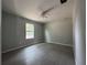 This bedroom has tile floors, a ceiling fan, natural light from a window, and neutral walls at 28 Bahia Pass Dr, Ocala, FL 34472